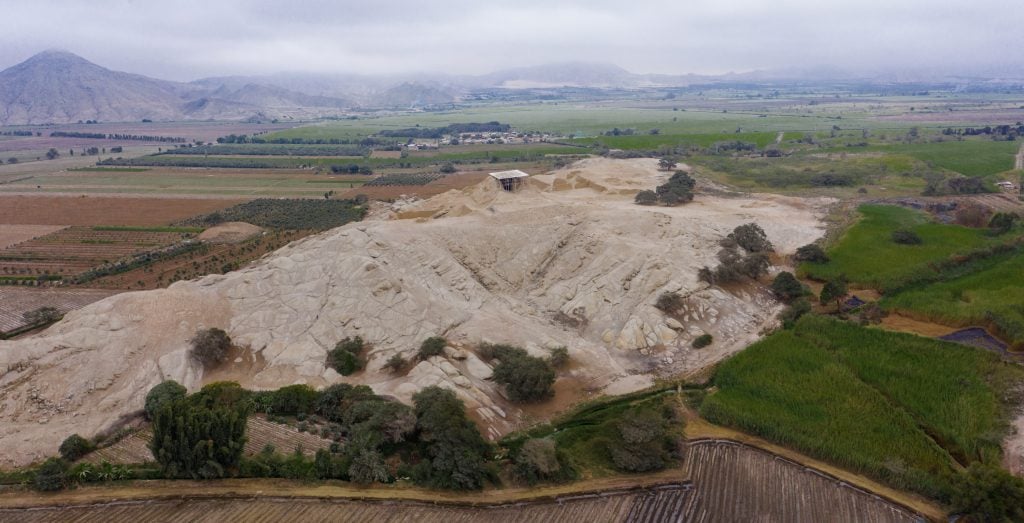 aerial photograph of landscape with hill of granite in the middle